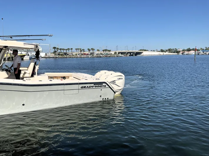  Yacht Photos Pics 2022 Grady-White 376 boat cruising on calm waters under clear blue sky.
