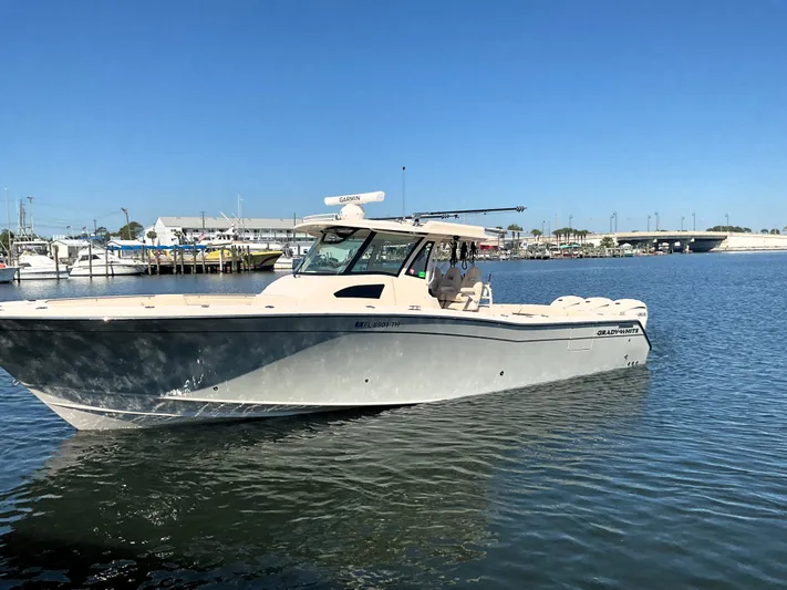  Yacht Photos Pics 2022 Grady-White 376 boat on calm water under clear blue sky.