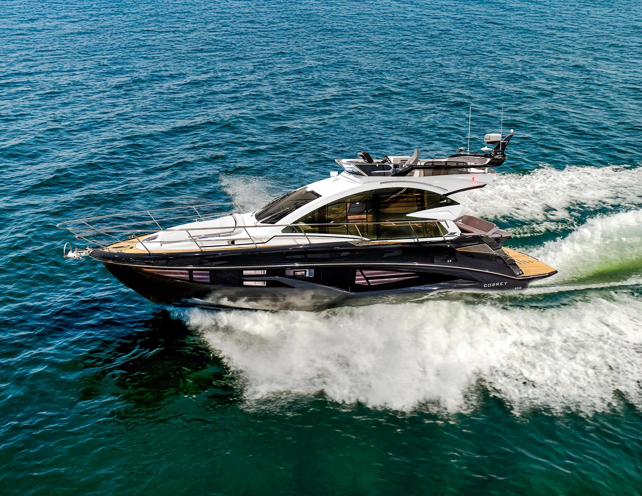 2025 Cobrey 45 FLY yacht cruising on open water, showcasing sleek design and luxury.