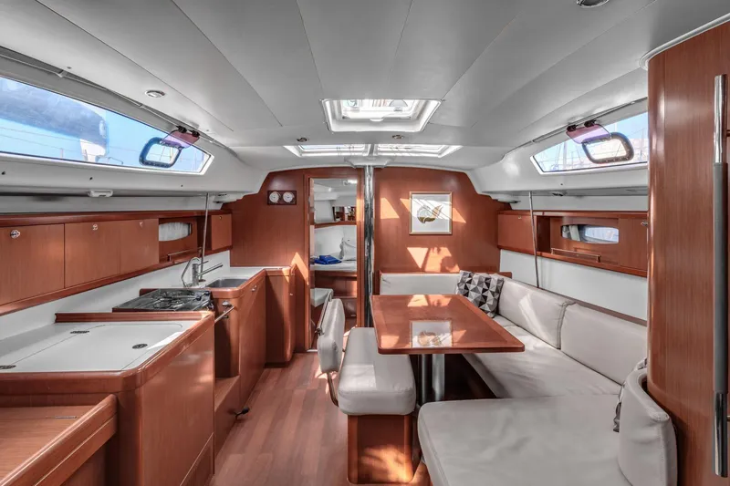 Pegasus Yacht Photos Pics Luxurious interior of 2011 Beneteau Oceanis 43 yacht with modern kitchen and dining area.