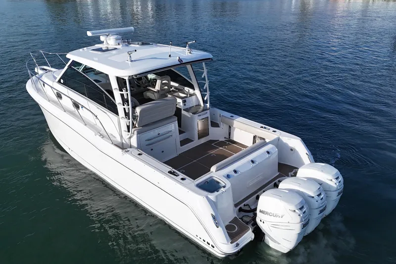 Whaler 345 Conquest - Loaded Yacht Photos Pics 2016 Boston Whaler 345 Conquest boat with triple Mercury engines on calm water.