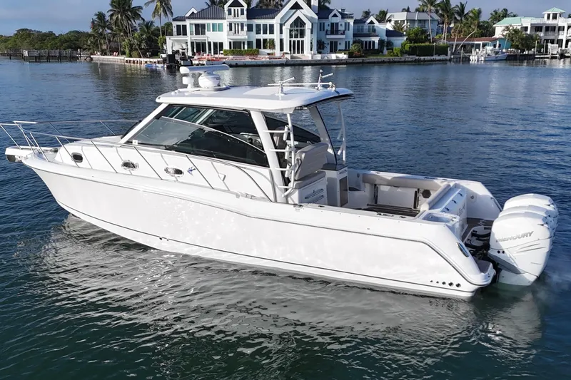 Whaler 345 Conquest - Loaded Yacht Photos Pics 2016 Boston Whaler 345 Conquest boat cruising near waterfront homes.