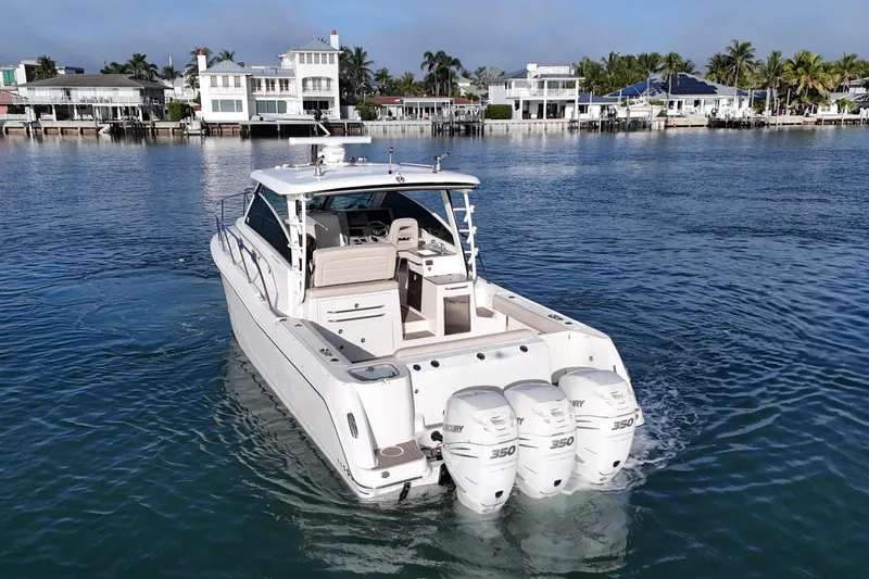 Whaler 345 Conquest - Loaded Yacht Photos Pics 2016 Boston Whaler 345 Conquest boat cruising near waterfront homes.