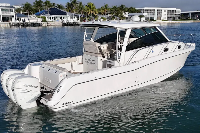 Whaler 345 Conquest - Loaded Yacht Photos Pics 2016 Boston Whaler 345 Conquest boat on calm water, featuring twin Mercury engines.