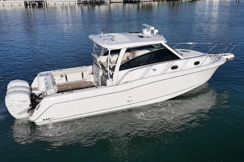 Whaler 345 Conquest - Loaded Yacht Photos Pics 2016 Boston Whaler 345 Conquest boat on calm water, featuring twin outboard engines.