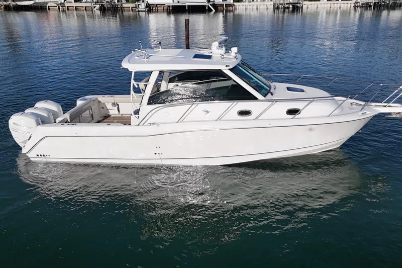 Whaler 345 Conquest - Loaded Yacht Photos Pics 2016 Boston Whaler 345 Conquest boat on calm water, side view.