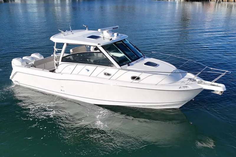 Whaler 345 Conquest - Loaded Yacht Photos Pics 2016 Boston Whaler 345 Conquest boat on calm water, showcasing sleek design.