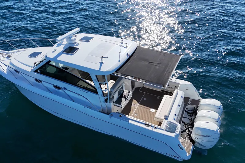 Whaler 345 Conquest - Loaded Yacht Photos Pics 2016 Boston Whaler 345 Conquest boat on sparkling blue water, aerial view.