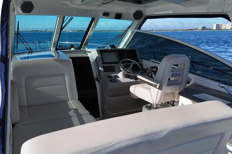 Whaler 345 Conquest - Loaded Yacht Photos Pics Interior view of 2016 Boston Whaler 345 Conquest boat, featuring helm and seating area.