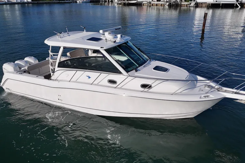 Whaler 345 Conquest - Loaded Yacht Photos Pics 2016 Boston Whaler 345 Conquest boat on calm water, showcasing sleek design and triple engines.