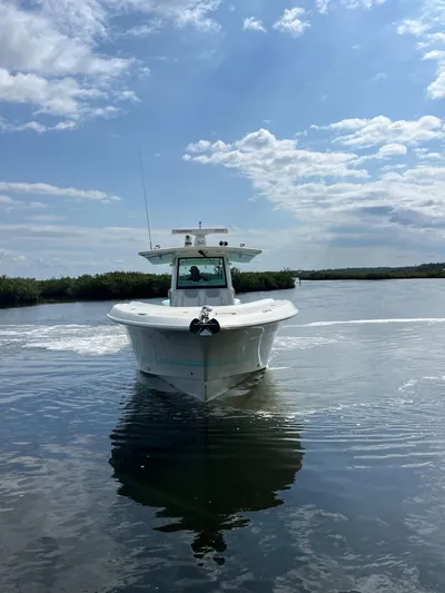  Yacht Photos Pics 2019 HCB Siesta boat cruising on calm water under a partly cloudy sky.