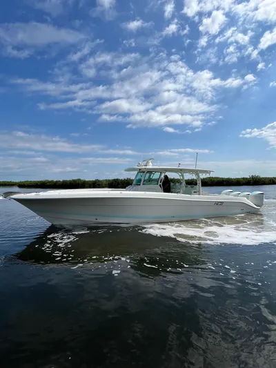  Yacht Photos Pics 2019 HCB Siesta boat cruising on a sunny day with blue skies and clouds.