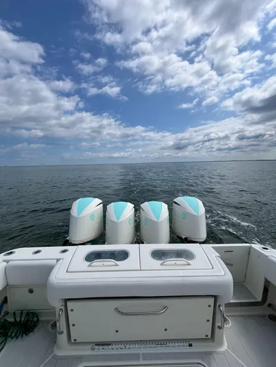  Yacht Photos Pics 2019 HCB Siesta boat with four engines on open water under a cloudy sky.