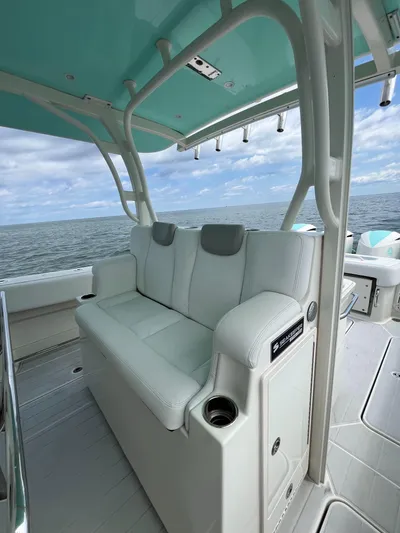  Yacht Photos Pics 2019 HCB Siesta boat with white seating, ocean view, and teal canopy.