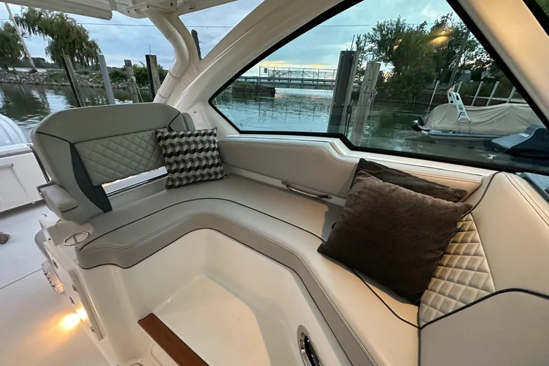  Yacht Photos Pics 2023 Pursuit DC 326 Dual Console interior with cushioned seating and decorative pillows.
