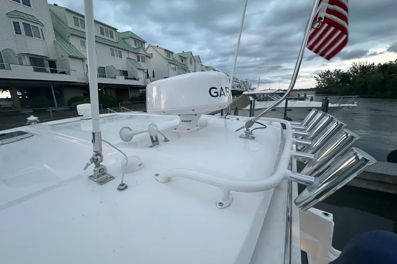  Yacht Photos Pics 2023 Pursuit DC 326 Dual Console boat docked, featuring radar and rod holders.