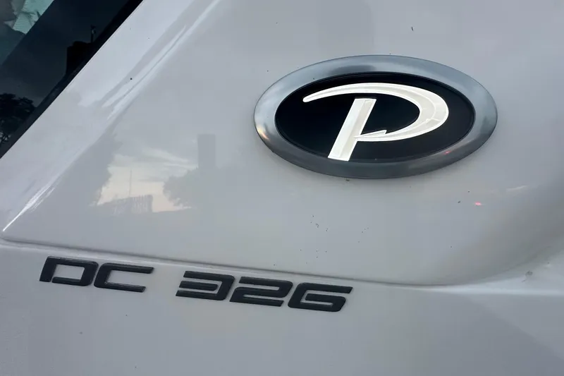  Yacht Photos Pics 2023 Pursuit DC 326 Dual Console logo and model name on boat exterior.
