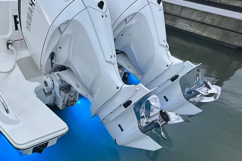  Yacht Photos Pics 2023 Pursuit DC 326 Dual Console boat with twin outboard engines and illuminated water.