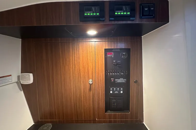  Yacht Photos Pics Control panel inside 2023 Pursuit DC 326 Dual Console boat, featuring wood finish and digital displays.