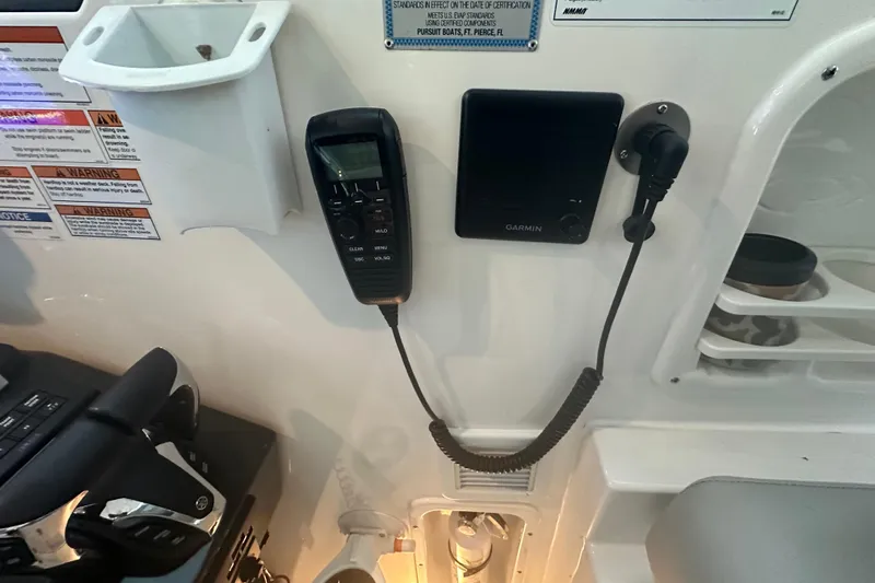  Yacht Photos Pics 2023 Pursuit DC 326 Dual Console boat dashboard with Garmin device and controls.