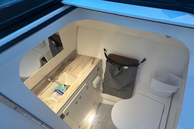  Yacht Photos Pics 2023 Pursuit DC 326 Dual Console boat interior with sink and storage.