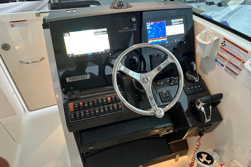 Yacht Photos Pics 2023 Pursuit DC 326 Dual Console boat dashboard with steering wheel and digital displays.