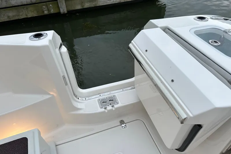  Yacht Photos Pics 2023 Pursuit DC 326 Dual Console boat deck with open transom door by the water.