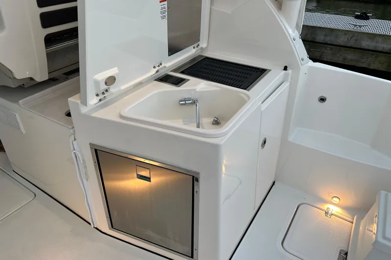  Yacht Photos Pics 2023 Pursuit DC 326 Dual Console boat with sink and storage area.