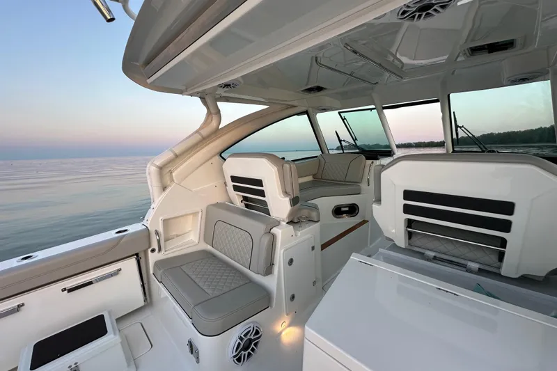  Yacht Photos Pics 2023 Pursuit DC 326 Dual Console boat interior with luxurious seating and ocean view.