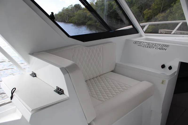  Yacht Photos Pics 2024 GENESIS 2700 Cuddy Cabin interior with quilted seating and window view.