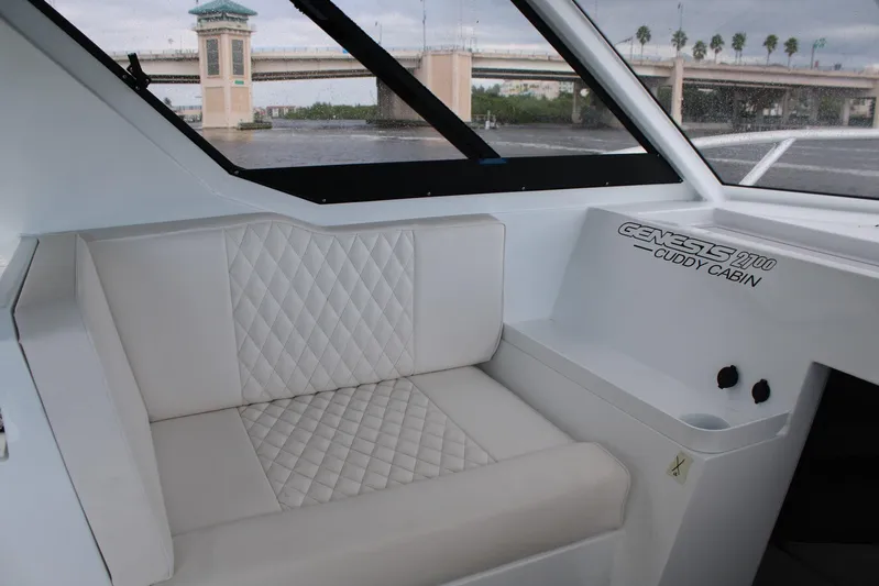  Yacht Photos Pics 2024 GENESIS 2700 Cuddy Cabin interior with quilted seating and window view.