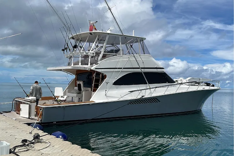Spey Yacht Photos Pics 2010 Viking 57 Convertible yacht docked, featuring fishing rods and a clear sky backdrop.