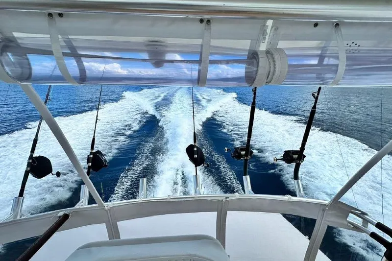 Spey Yacht Photos Pics 2010 Viking 57 Convertible yacht cruising with fishing rods, leaving a wake in the ocean.