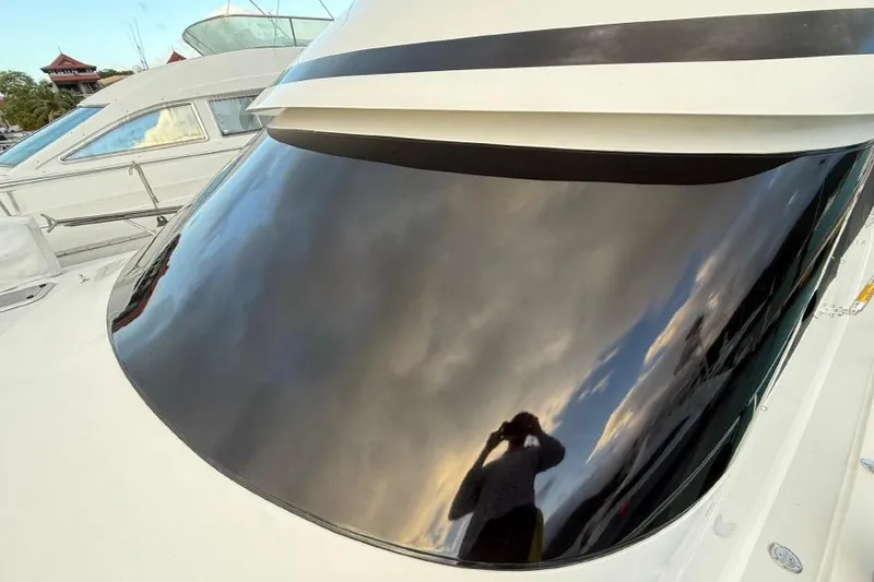 Spey Yacht Photos Pics 2010 Viking 57 Convertible yacht with reflective windshield, capturing sky and person.