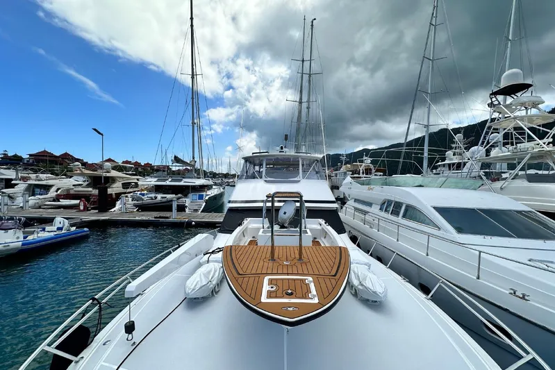 Spey Yacht Photos Pics 2010 Viking 57 Convertible yacht docked in a marina under cloudy skies.