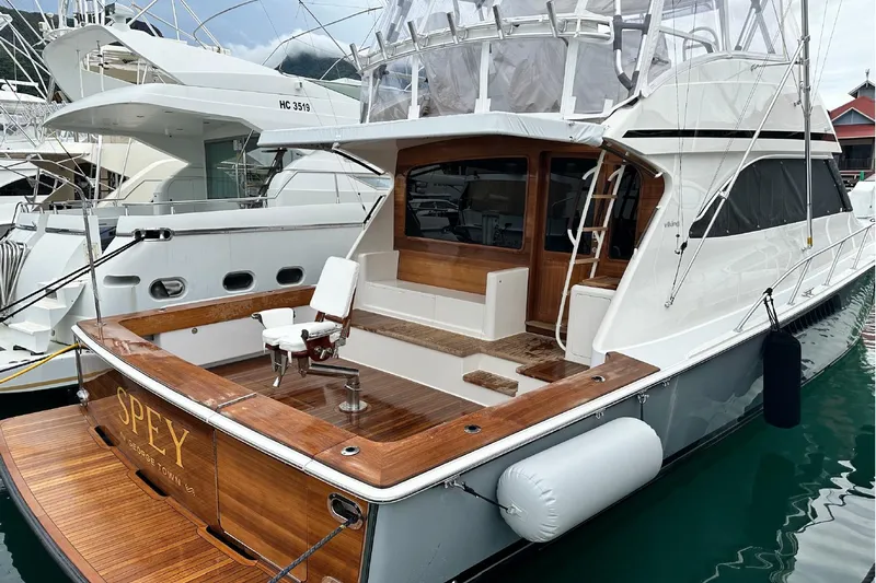 Spey Yacht Photos Pics 2010 Viking 57 Convertible yacht docked, featuring a spacious wooden deck and fishing chair.