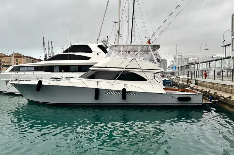 Spey Yacht Photos Pics 2010 Viking 57 Convertible yacht docked in a marina, overcast sky.
