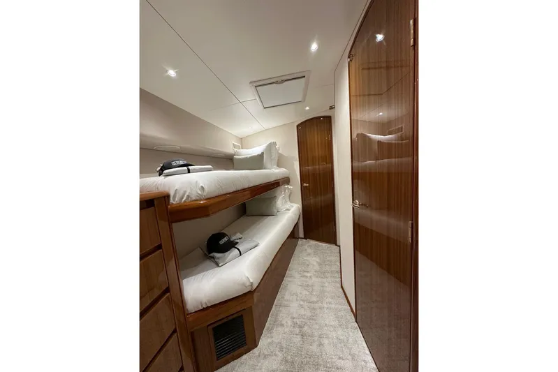 Spey Yacht Photos Pics Interior of 2010 Viking 57 Convertible yacht with bunk beds and wooden cabinetry.