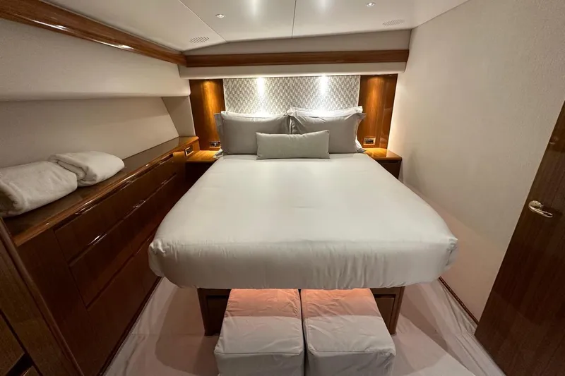 Spey Yacht Photos Pics Luxurious bedroom interior of 2010 Viking 57 Convertible yacht with elegant wood finishes.