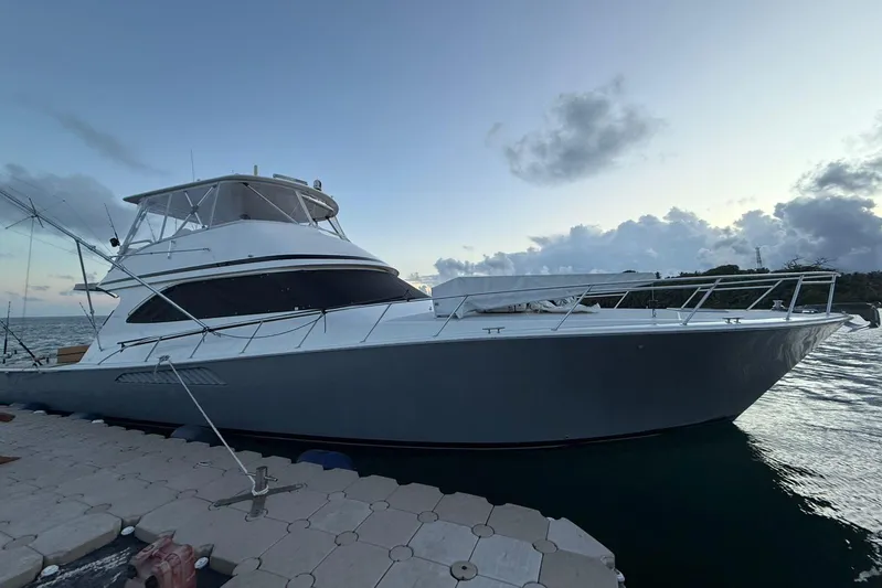 Spey Yacht Photos Pics 2010 Viking 57 Convertible yacht docked at sunset, showcasing sleek design and luxury.