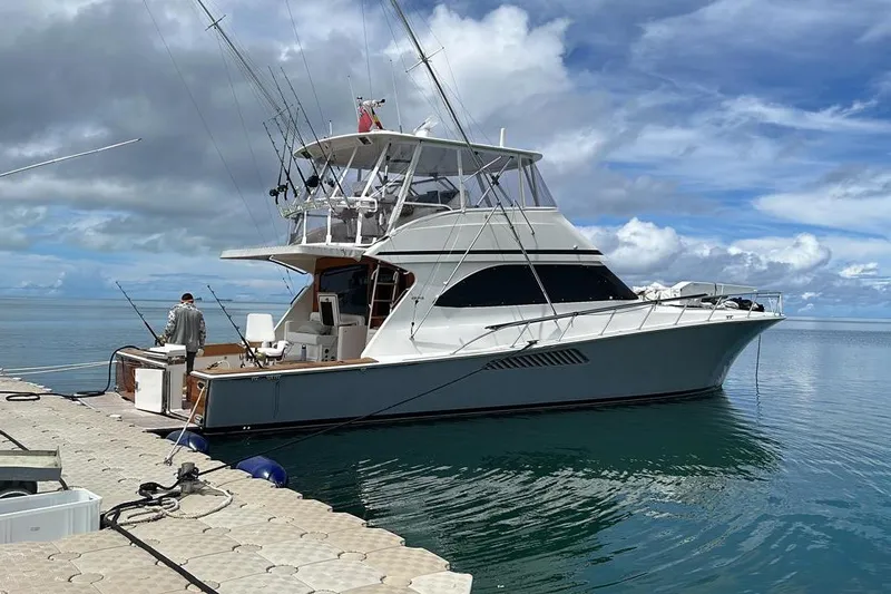 Spey Yacht Photos Pics 2010 Viking 57 Convertible yacht docked, featuring fishing rods and a clear blue sky.