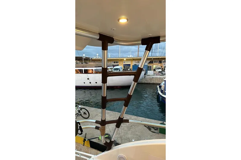 Spey Yacht Photos Pics Ladder on 2010 Viking 57 Convertible yacht, docked at marina with boats in background.