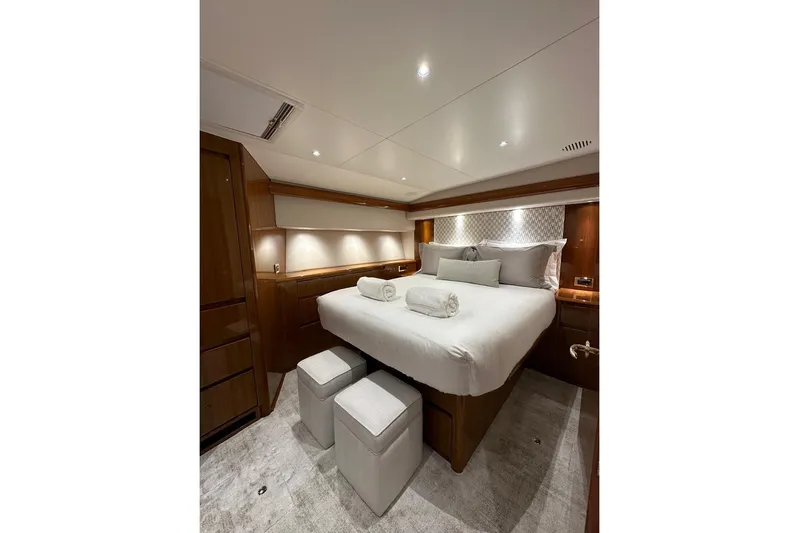 Spey Yacht Photos Pics Luxurious bedroom interior of 2010 Viking 57 Convertible yacht with elegant wood finishes.