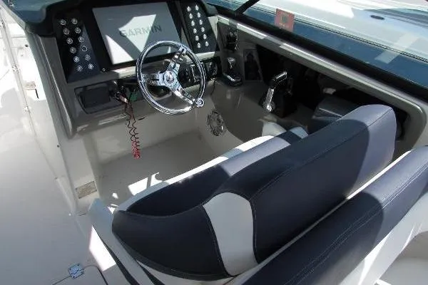 317-147 Brokerage Ray Yacht Photos Pics 2018 Robalo R317 Dual Console boat cockpit with steering wheel and Garmin display.