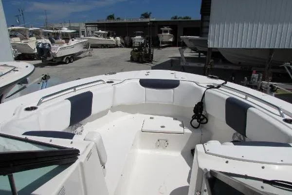 317-147 Brokerage Ray Yacht Photos Pics 2018 Robalo R317 Dual Console boat with spacious seating in a marina setting.