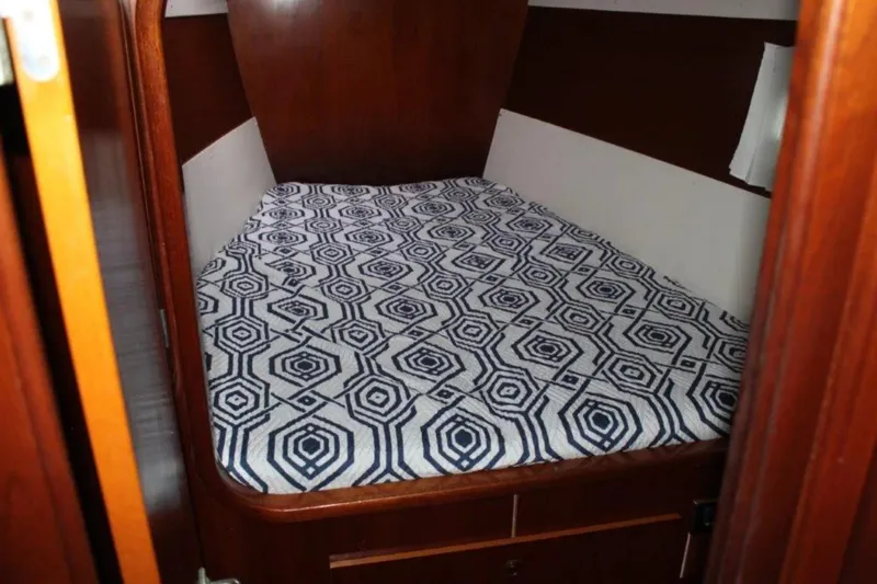 Mangata Yacht Photos Pics Cozy cabin bed with geometric patterned bedding in 2003 Lagoon Power 43 yacht.