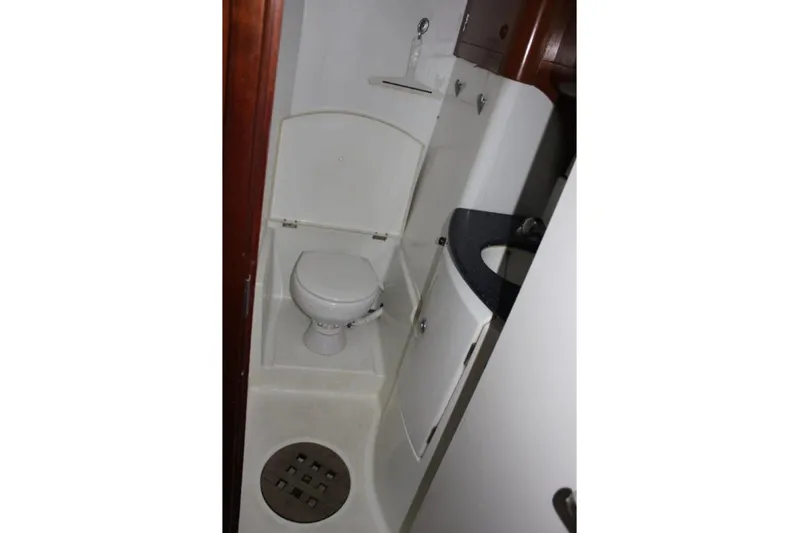 Mangata Yacht Photos Pics Compact bathroom in 2003 Lagoon Power 43 yacht, featuring toilet and sink.