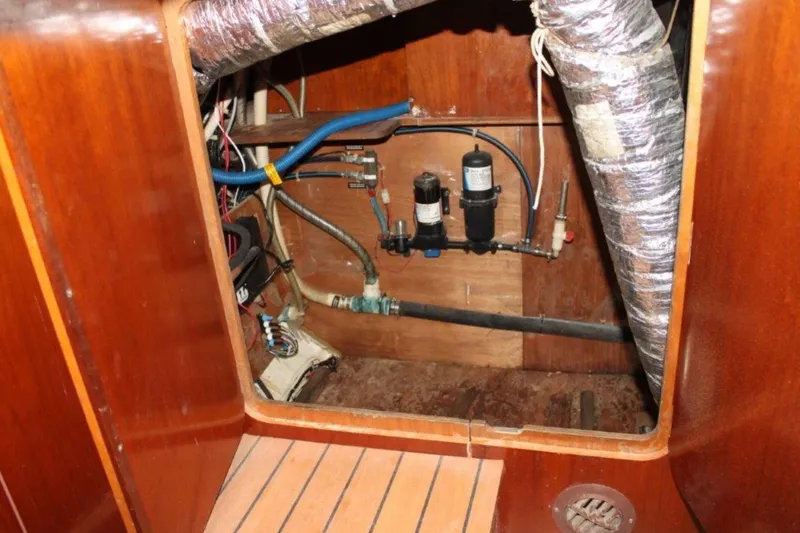 Mangata Yacht Photos Pics Engine compartment of a 2003 Lagoon Power 43 boat, showing pipes and wiring.