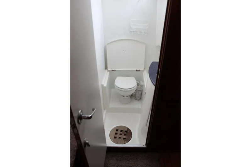 Mangata Yacht Photos Pics Compact bathroom in 2003 Lagoon Power 43 yacht, featuring a toilet and shower area.