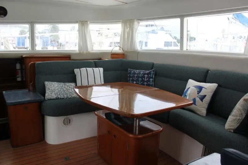 Mangata Yacht Photos Pics Interior of 2003 Lagoon Power 43 yacht with cozy seating and decorative pillows.
